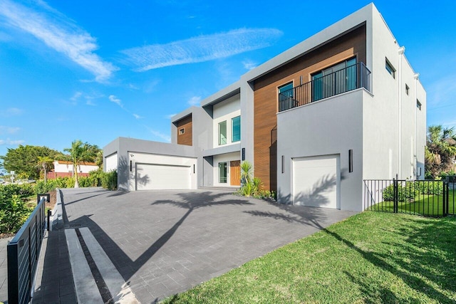 13480 US Highway 1, Juno Beach, FL 33408 - modern home with stucco siding, driveway, and a balcony