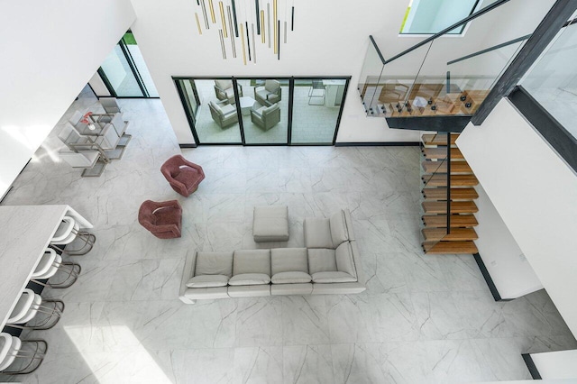 13480 US Highway 1, Juno Beach, FL 33408 - unfurnished living room with tile walls and a towering ceiling