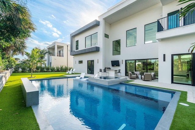 13480 US Highway 1, Juno Beach, FL 33408 - view of swimming pool featuring outdoor lounge area, a lawn, a patio, and a pool with connected hot tub
