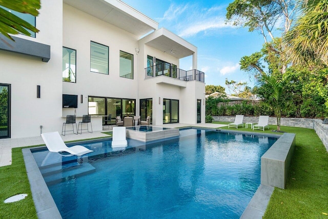 13480 US Highway 1, Juno Beach, FL 33408 - view of swimming pool featuring a patio area, a lawn, an outdoor bar, and a pool with connected hot tub