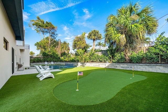 13480 US Highway 1, Juno Beach, FL 33408 - fenced backyard featuring an area to practice putting and a balcony