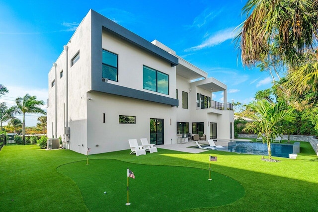 13480 US Highway 1, Juno Beach, FL 33408 - rear view of house featuring a balcony, an area to practice putting, a patio area, and stucco siding