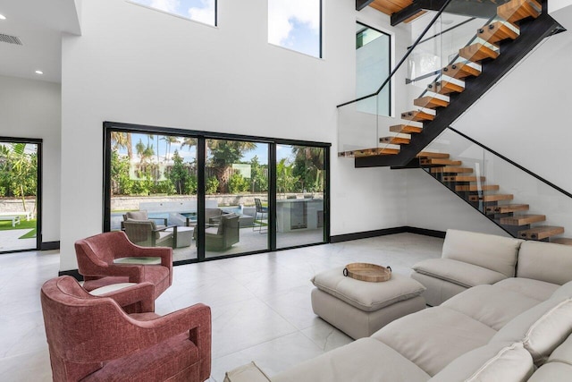 13480 US Highway 1, Juno Beach, FL 33408 - living room with a towering ceiling, stairs, and recessed lighting