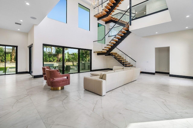 13480 US Highway 1, Juno Beach, FL 33408 - living area featuring a high ceiling, marble tiled flooring, stairway, and recessed lighting