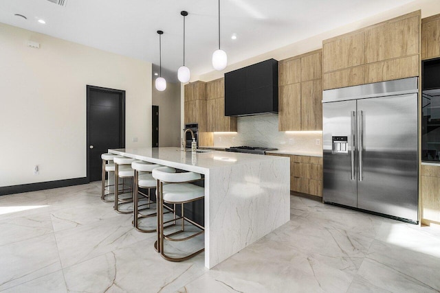 13480 US Highway 1, Juno Beach, FL 33408 - kitchen with stainless steel built in refrigerator, exhaust hood, modern cabinets, light marble finish floors, and recessed lighting