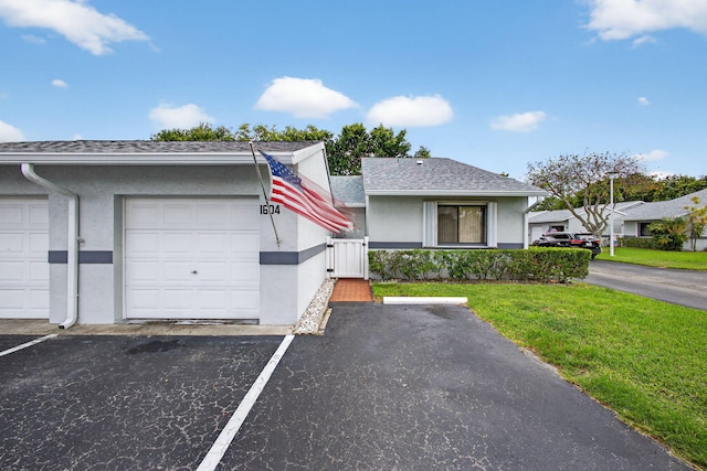 2640 Gately Dr W Unit 1604, West Palm Beach, FL 33415 - view of front of home with stucco siding, a gate, and uncovered parking