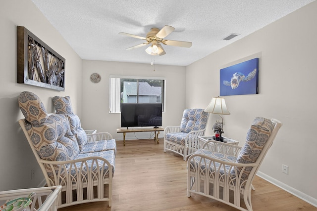 2640 Gately Dr W Unit 1604, West Palm Beach, FL 33415 - living area with a ceiling fan, wood finished floors, and a textured ceiling
