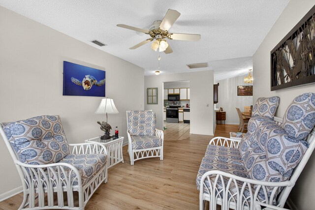 2640 Gately Dr W Unit 1604, West Palm Beach, FL 33415 - sitting room featuring wood finished floors, ceiling fan, and a textured ceiling