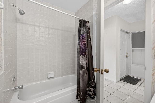2640 Gately Dr W Unit 1604, West Palm Beach, FL 33415 - bathroom featuring shower / bathtub combination with curtain, tile patterned floors, and a textured ceiling