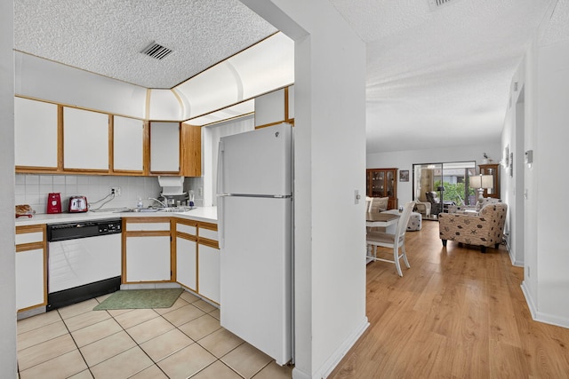 2640 Gately Dr W Unit 1604, West Palm Beach, FL 33415 - kitchen with white appliances, a textured ceiling, light countertops, white cabinets, and open floor plan