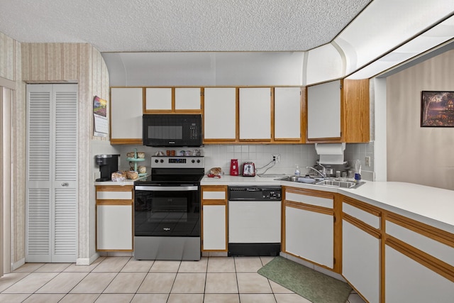 2640 Gately Dr W Unit 1604, West Palm Beach, FL 33415 - kitchen featuring dishwasher, black microwave, stainless steel range with electric stovetop, light countertops, and light tile patterned floors