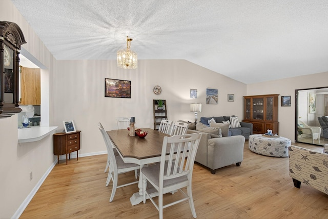 2640 Gately Dr W Unit 1604, West Palm Beach, FL 33415 - dining room with light wood-style flooring, lofted ceiling, a chandelier, and a textured ceiling