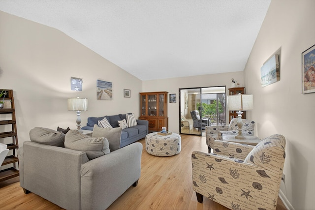 2640 Gately Dr W Unit 1604, West Palm Beach, FL 33415 - living room with vaulted ceiling and light wood-style flooring