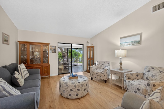 2640 Gately Dr W Unit 1604, West Palm Beach, FL 33415 - living room featuring wood finished floors and vaulted ceiling