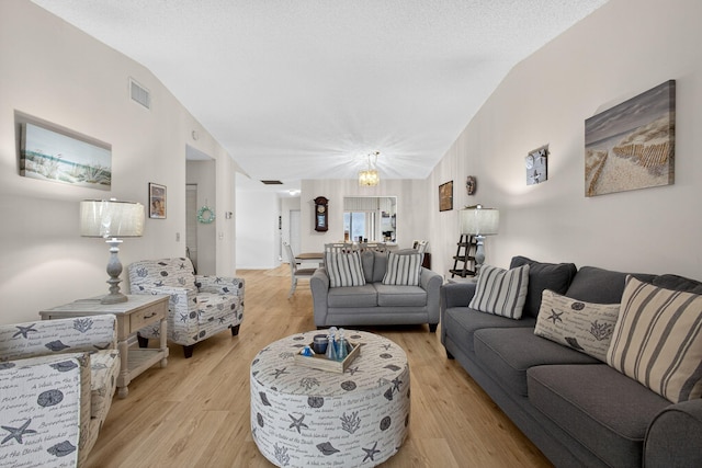 2640 Gately Dr W Unit 1604, West Palm Beach, FL 33415 - living room with light wood-type flooring, vaulted ceiling, and a chandelier