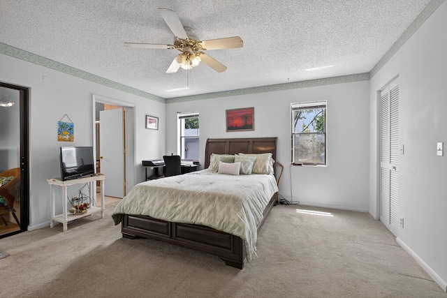 2640 Gately Dr W Unit 1604, West Palm Beach, FL 33415 - bedroom featuring a textured ceiling, multiple windows, light colored carpet, and ceiling fan