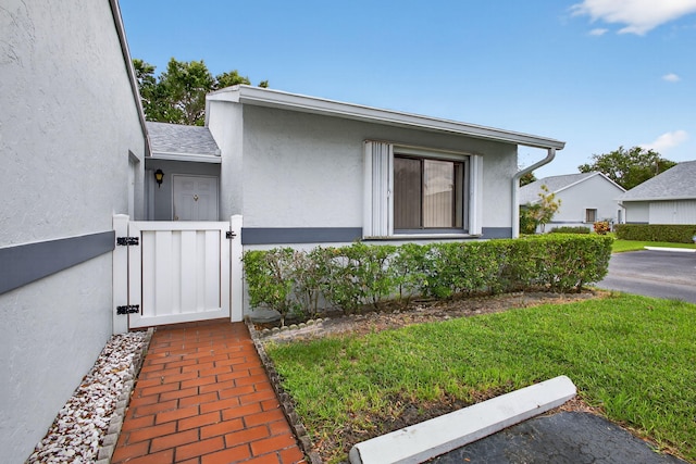 2640 Gately Dr W Unit 1604, West Palm Beach, FL 33415 - view of front of property featuring a gate and stucco siding