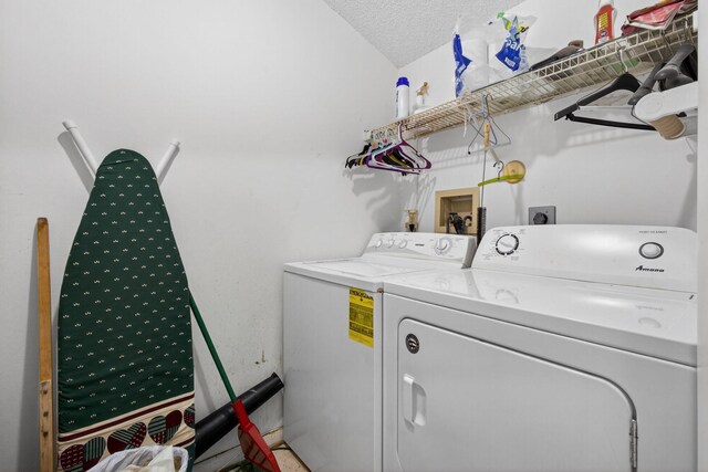 2640 Gately Dr W Unit 1604, West Palm Beach, FL 33415 - laundry area featuring washer and clothes dryer and a textured ceiling