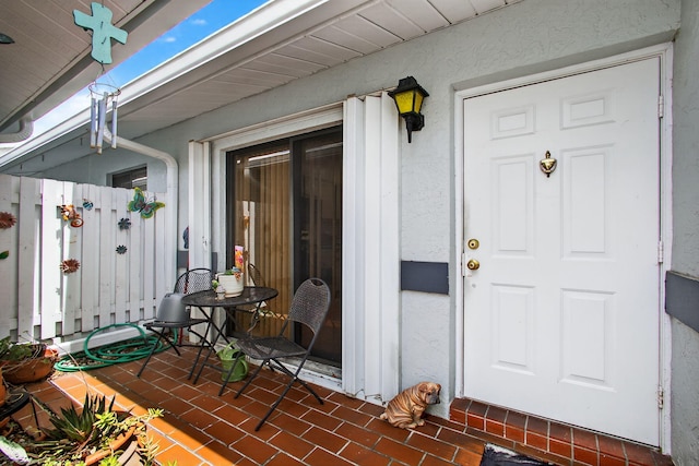 2640 Gately Dr W Unit 1604, West Palm Beach, FL 33415 - doorway to property featuring stucco siding and covered porch