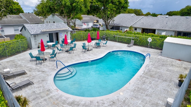 2640 Gately Dr W Unit 1604, West Palm Beach, FL 33415 - community pool with a patio area and a residential view