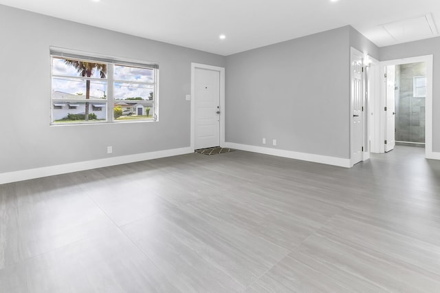7609 NW 70th Ave, Tamarac, FL 33321 - unfurnished living room with attic access and recessed lighting