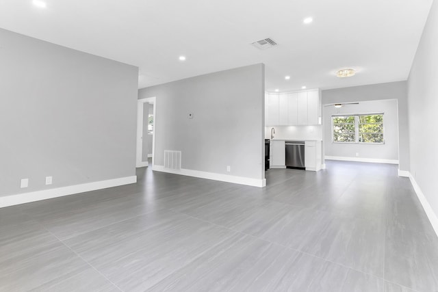 7609 NW 70th Ave, Tamarac, FL 33321 - unfurnished living room with baseboards and recessed lighting