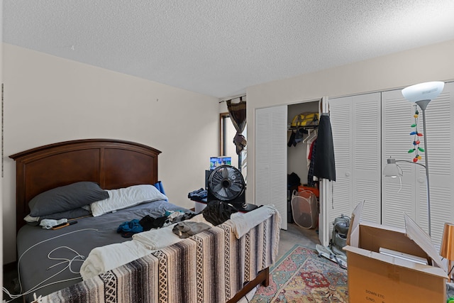 5310 Pebble Beach Dr Unit F, Orlando, FL 32811 - bedroom with multiple closets, a textured ceiling, and carpet flooring