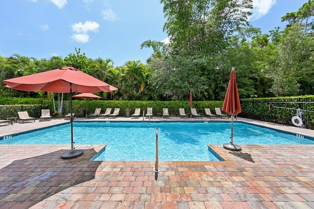 2808 Troubadour St, Palm Springs, FL 33406 - community pool with a patio area and view of wooded area