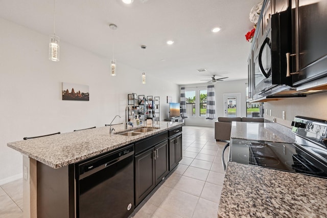 2808 Troubadour St, Palm Springs, FL 33406 - kitchen featuring dishwasher, stainless steel electric range, open floor plan, a kitchen island with sink, and light stone counters