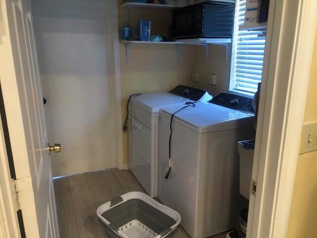7992 Chula Vista Cres, Boca Raton, FL 33433 - laundry area featuring washer and dryer and light wood-type flooring