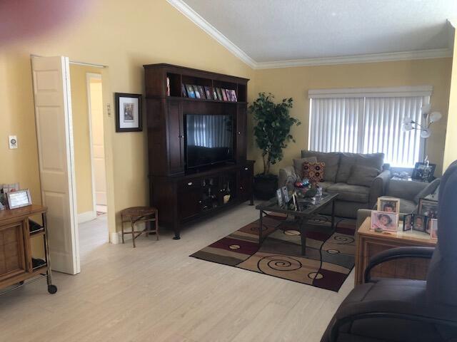 7992 Chula Vista Cres, Boca Raton, FL 33433 - living area with lofted ceiling, crown molding, and wood finished floors