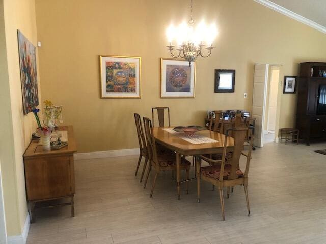 7992 Chula Vista Cres, Boca Raton, FL 33433 - dining area featuring a chandelier, light wood-type flooring, vaulted ceiling, and ornamental molding