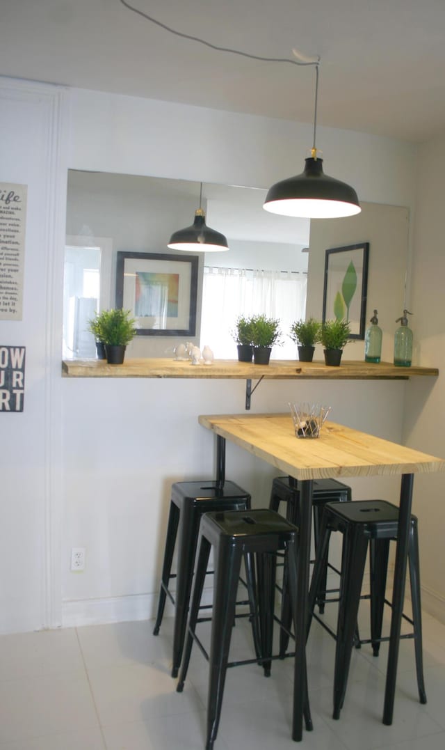 440 NE 1st Ave, Fort Lauderdale, FL 33301 - dining space with baseboards and light tile patterned flooring