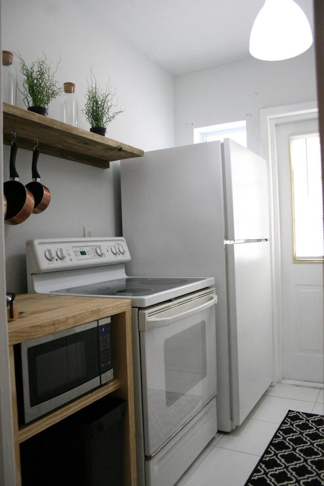440 NE 1st Ave, Fort Lauderdale, FL 33301 - kitchen featuring white electric stove, stainless steel microwave, and light tile patterned floors