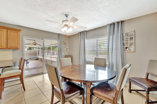 1234 SE Petunia Ave, Port Saint Lucie, FL 34952 - dining area featuring a ceiling fan, plenty of natural light, light tile patterned floors, and a textured ceiling