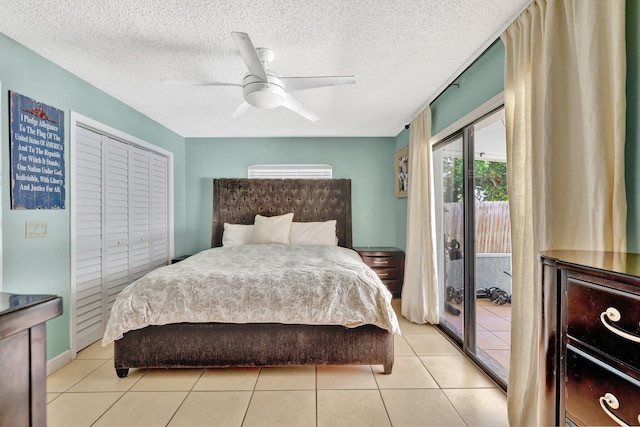 1234 SE Petunia Ave, Port Saint Lucie, FL 34952 - bedroom featuring access to outside, ceiling fan, a textured ceiling, light tile patterned flooring, and a closet