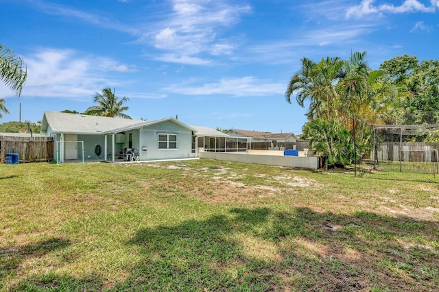 1234 SE Petunia Ave, Port Saint Lucie, FL 34952 - rear view of house with a fenced backyard, stucco siding, and a sunroom