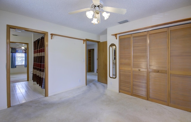 5176 Palm Way N, Lake Worth, FL 33463 - unfurnished bedroom with carpet, a closet, a textured ceiling, and ceiling fan