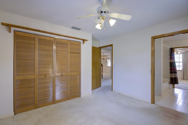 5176 Palm Way N, Lake Worth, FL 33463 - unfurnished bedroom featuring light colored carpet, a textured ceiling, a closet, and ceiling fan