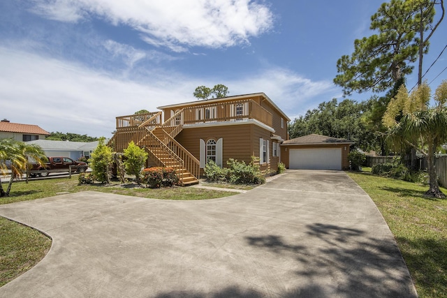 5176 Palm Way N, Lake Worth, FL 33463 - front facade with stairs, an outbuilding, a deck, and a detached garage
