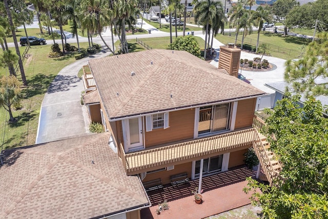 5176 Palm Way N, Lake Worth, FL 33463 - rear view of house featuring roof with shingles, a chimney, and stairs