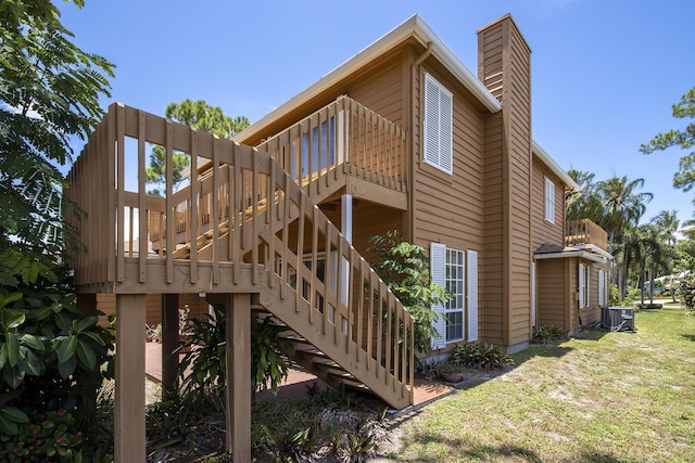 5176 Palm Way N, Lake Worth, FL 33463 - back of house with a chimney, a yard, and stairs