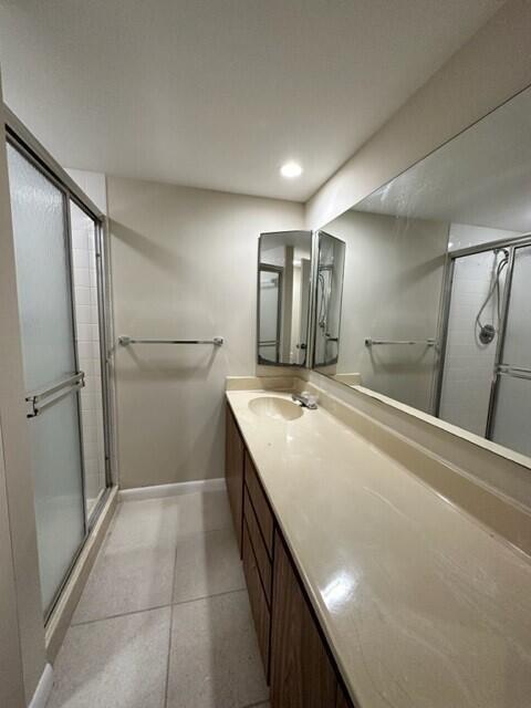 3310 33rd Way, West Palm Beach, FL 33407 - bathroom featuring a stall shower, vanity, tile patterned flooring, and recessed lighting