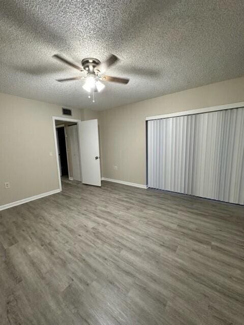 3310 33rd Way, West Palm Beach, FL 33407 - empty room featuring a ceiling fan, wood finished floors, and a textured ceiling