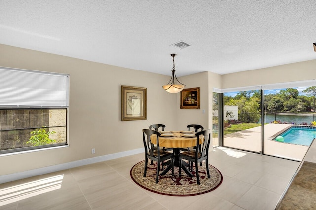 6526 Sweet Maple Ln, Boca Raton, FL 33433 - dining area with light tile patterned floors and a textured ceiling