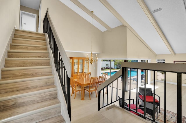 6526 Sweet Maple Ln, Boca Raton, FL 33433 - staircase featuring a chandelier, high vaulted ceiling, and beamed ceiling
