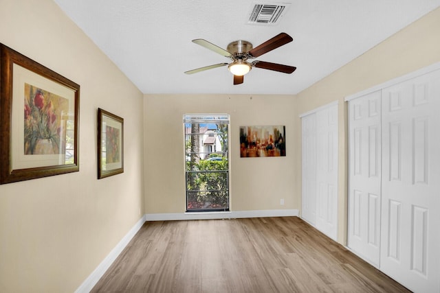 6526 Sweet Maple Ln, Boca Raton, FL 33433 - unfurnished bedroom featuring two closets, wood finished floors, and a ceiling fan