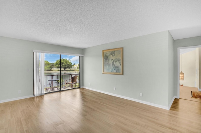 6526 Sweet Maple Ln, Boca Raton, FL 33433 - spare room featuring wood finished floors and a textured ceiling