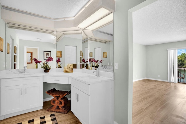 6526 Sweet Maple Ln, Boca Raton, FL 33433 - bathroom with wood finished floors, a textured ceiling, and double vanity
