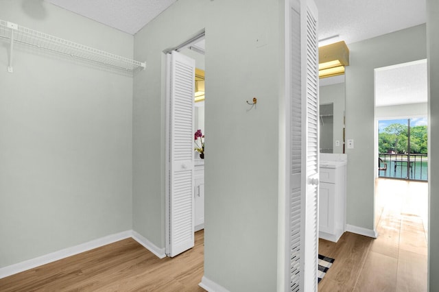 6526 Sweet Maple Ln, Boca Raton, FL 33433 - corridor featuring wood finished floors and a textured ceiling